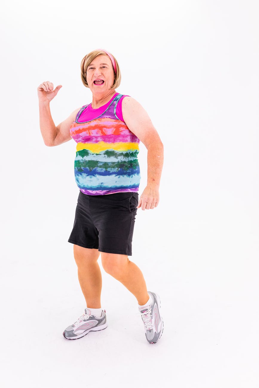 elderly woman in black shorts and colorful sleveless shirt