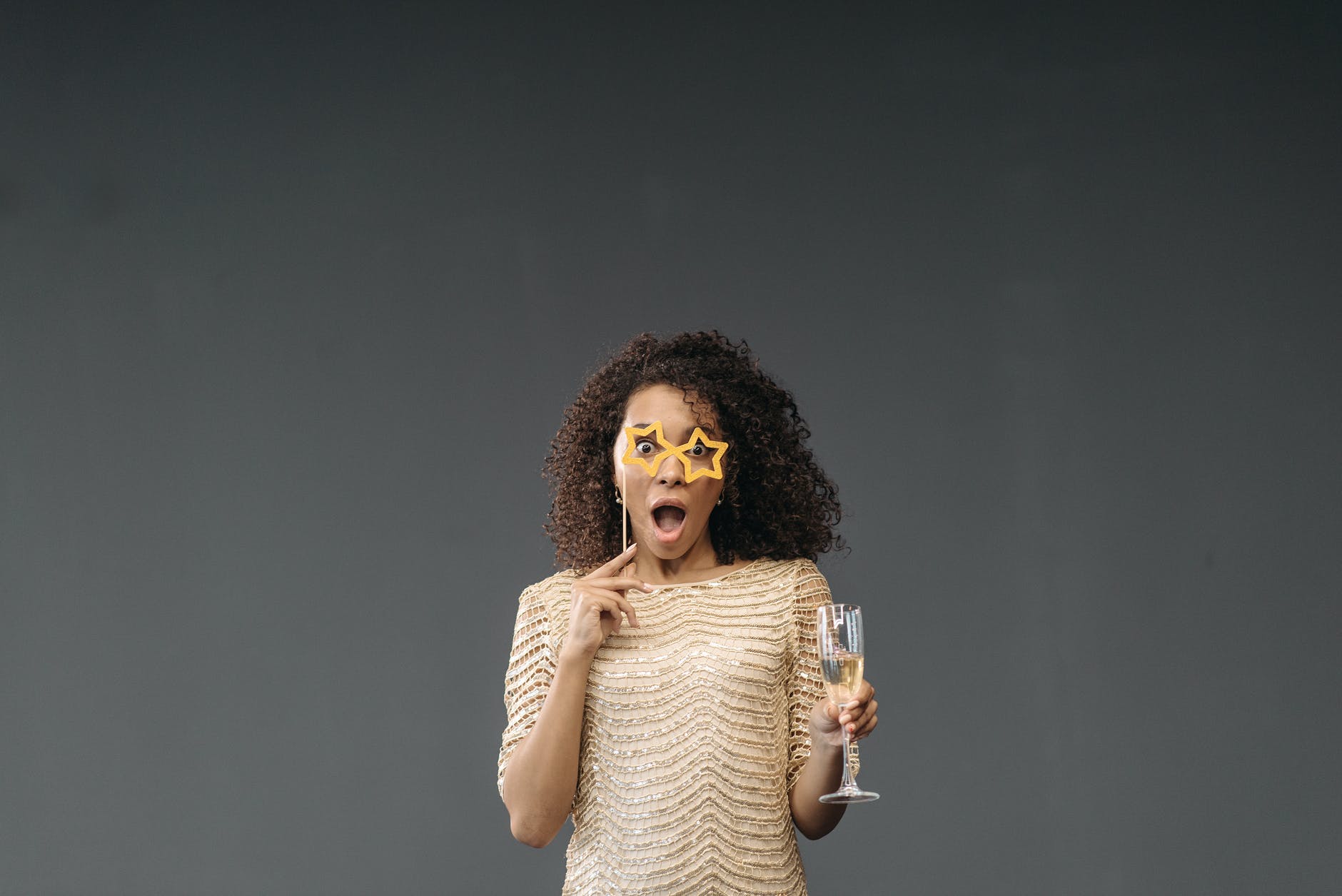 surprised woman holding glass of champagne