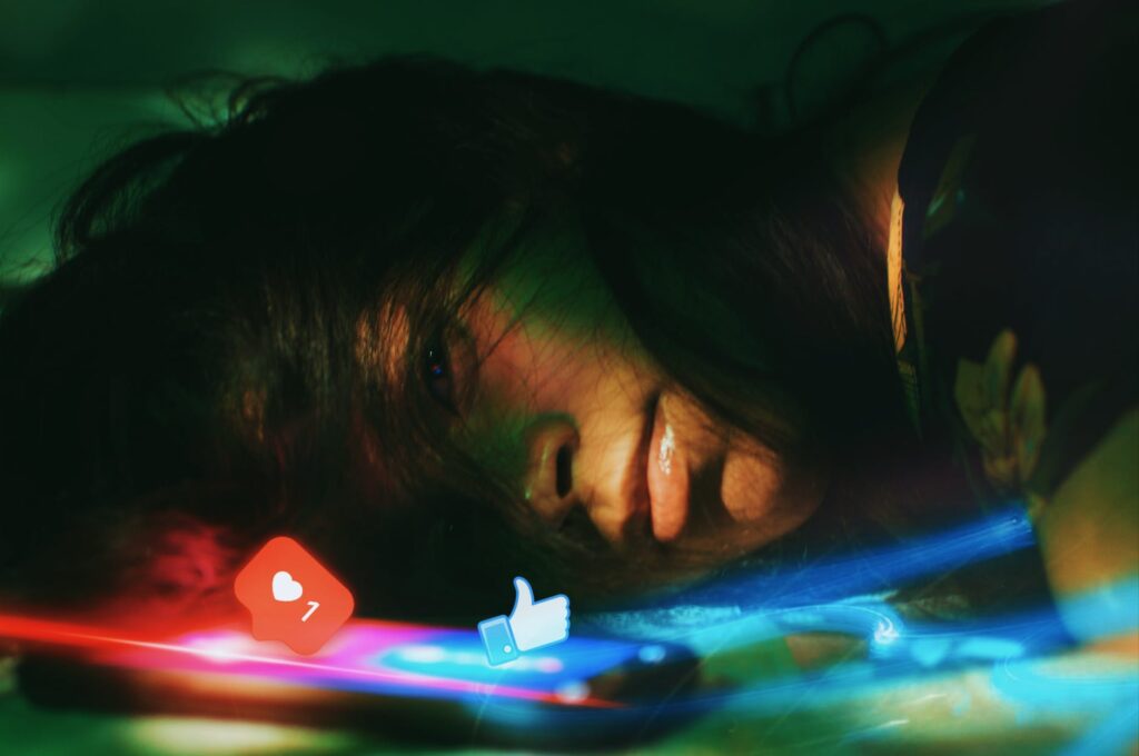 photo of woman lying beside a phone
