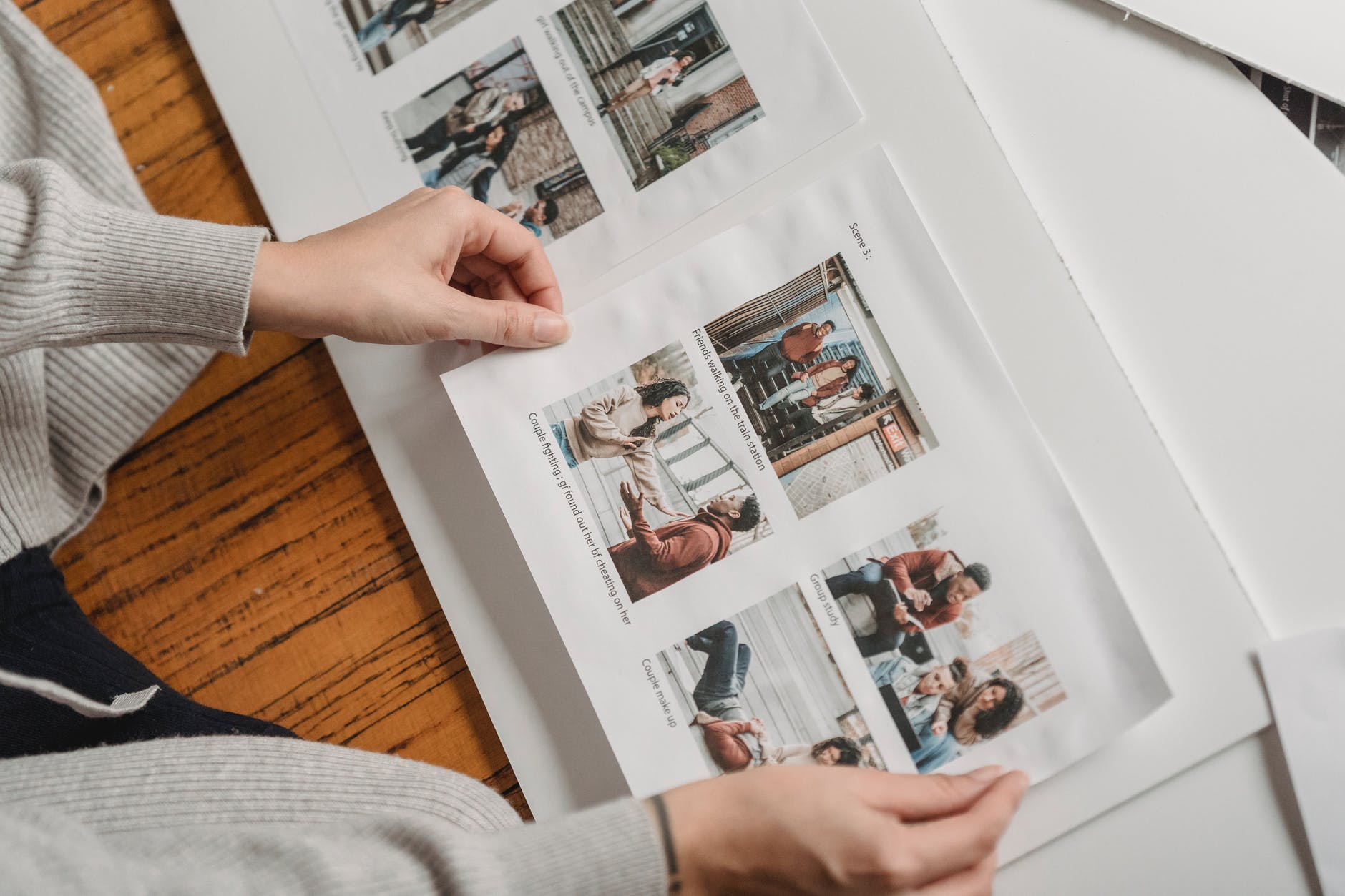 unrecognizable person pasting photos in family album