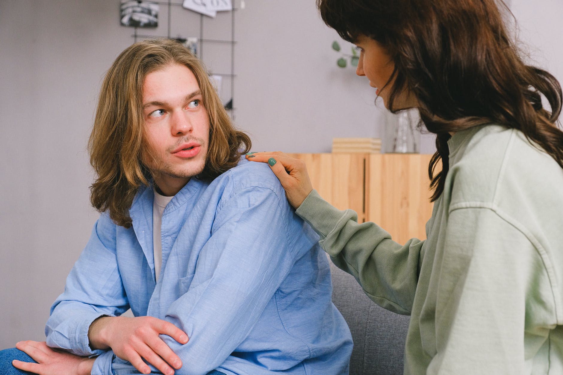 woman talking with male in light room